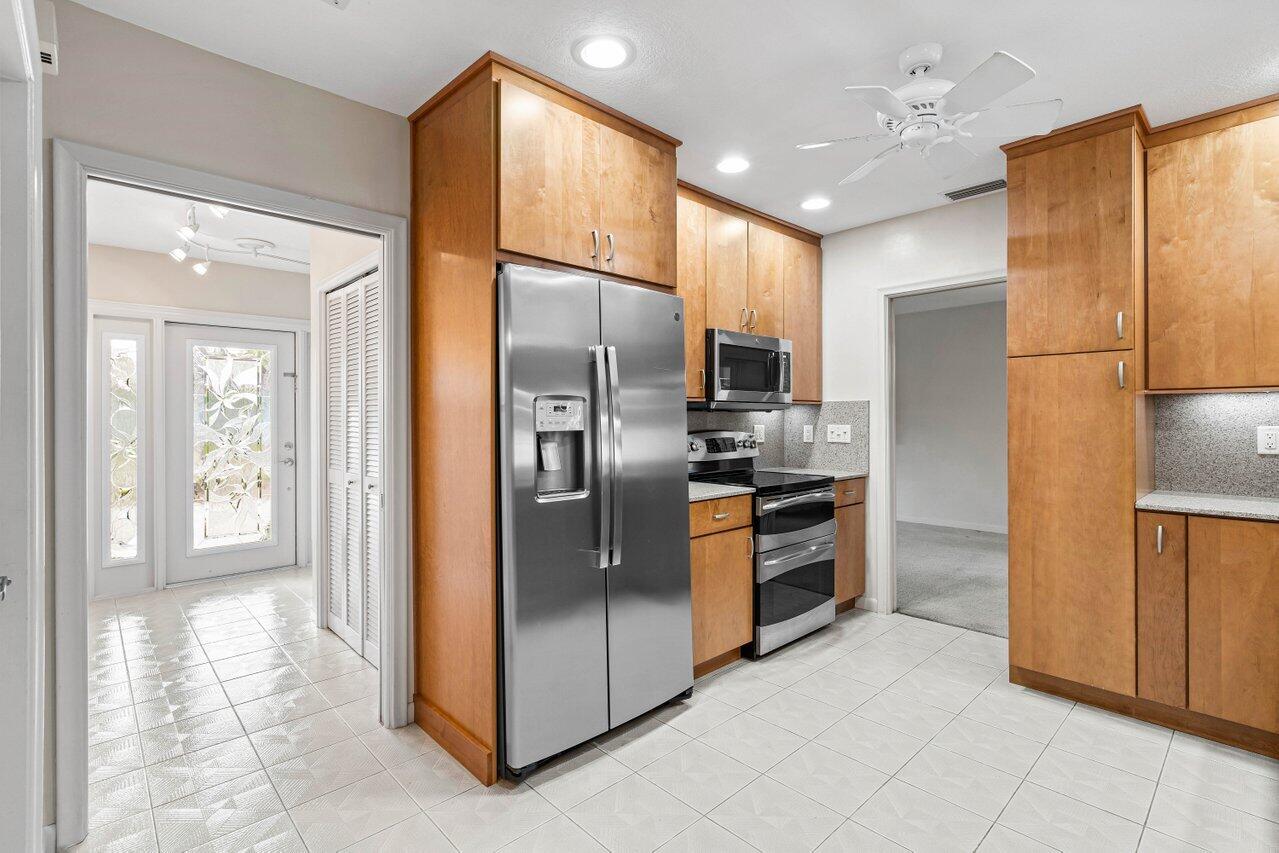 643 Northwest 11th Avenue Boca Raton, FL 33486 - Photo 13 of 37 Foyer entry leads to kitchen