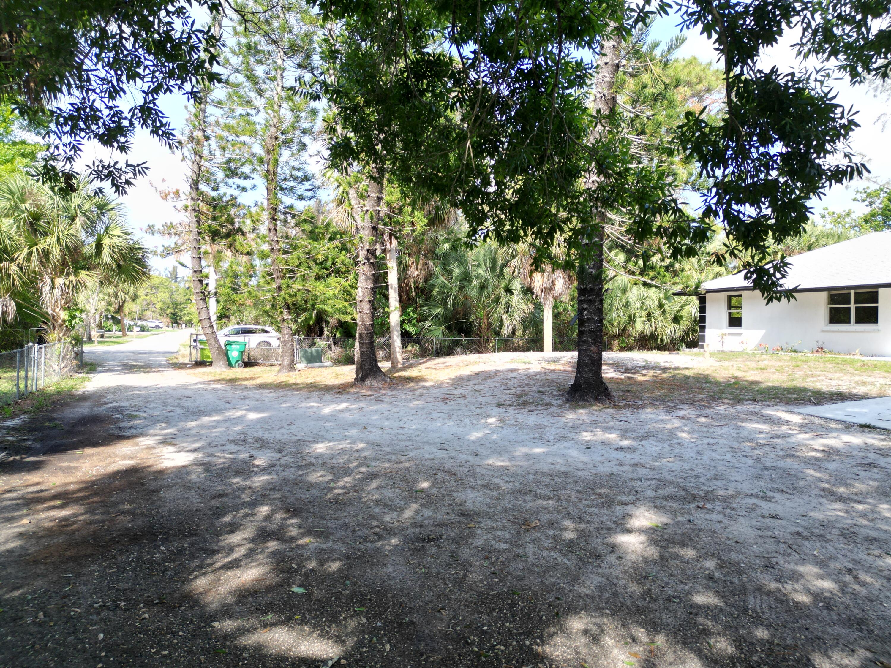 14523 Flamingo Road Loxahatchee Groves, FL 33470 - Photo 2 of 50 a view of road with trees