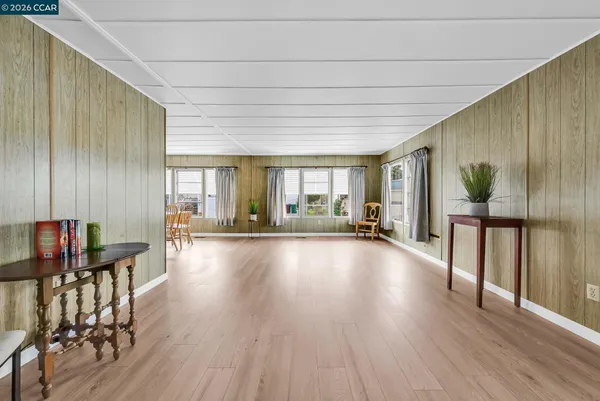 a dining room with furniture window and wooden floor