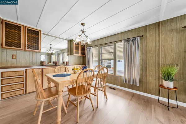 a view of a dining room with furniture large window and wooden floor