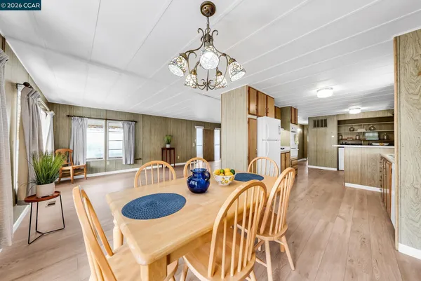 a kitchen with stainless steel appliances a refrigerator a stove a sink and a refrigerator with wooden floor