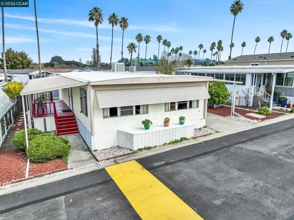 a view of a house with a swimming pool and sitting area