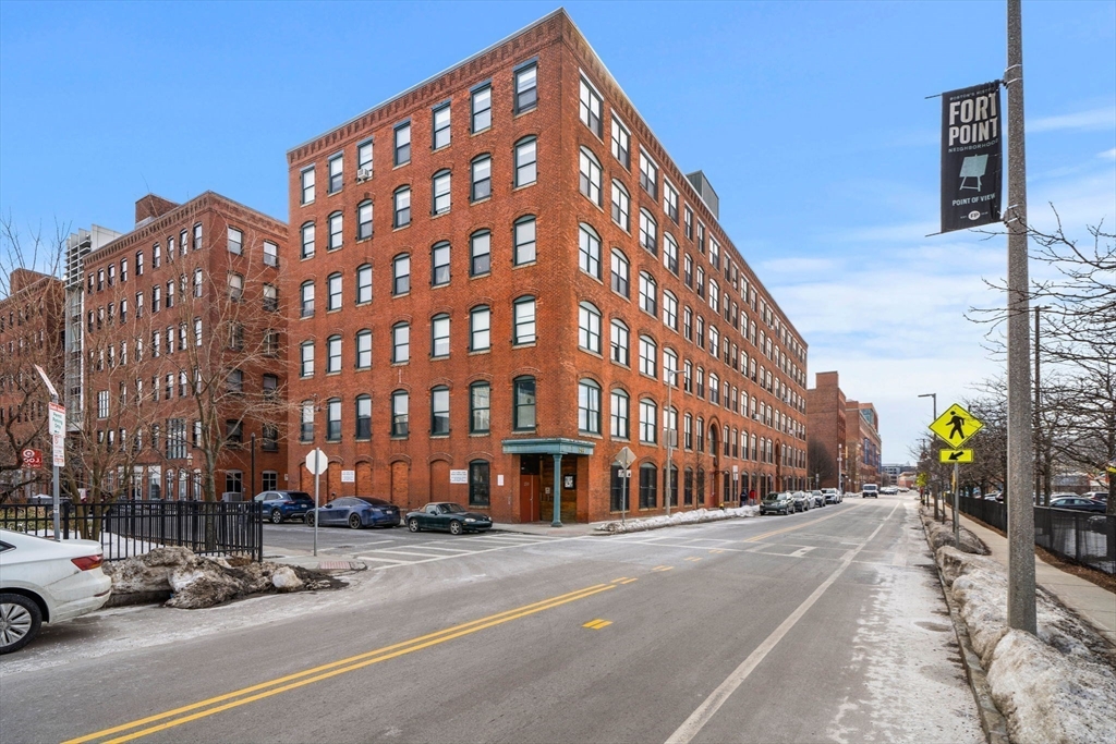 259 A Street, Unit 21 Boston, MA 02210 - Photo 17 of 18 a city street lined with parked cars and buildings