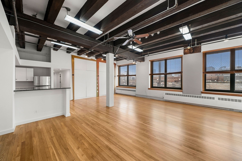 259 A Street, Unit 21 Boston, MA 02210 - Photo 2 of 18 a view of water heater room with wooden floor