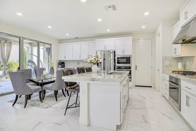 a view of a dining room with furniture and a window