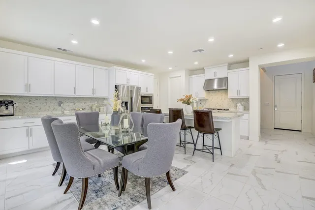 a dining room with furniture and wooden floor