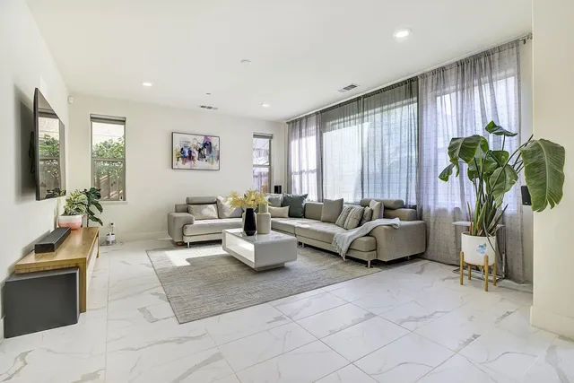 a living room with furniture wooden floor and a flat screen tv