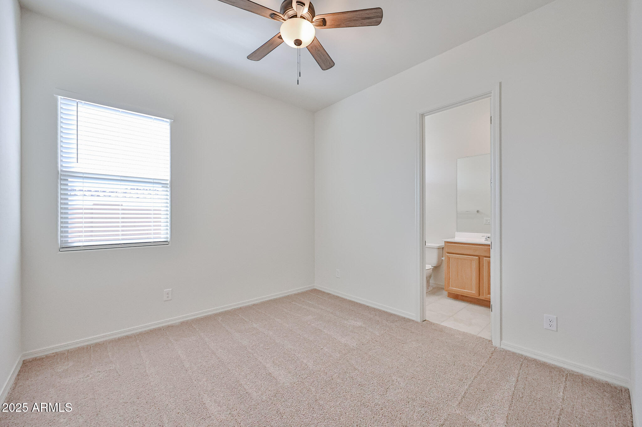 25079 North 171st Avenue Surprise, AZ 85387 - Photo 14 of 22 an empty room with a window and a ceiling fan