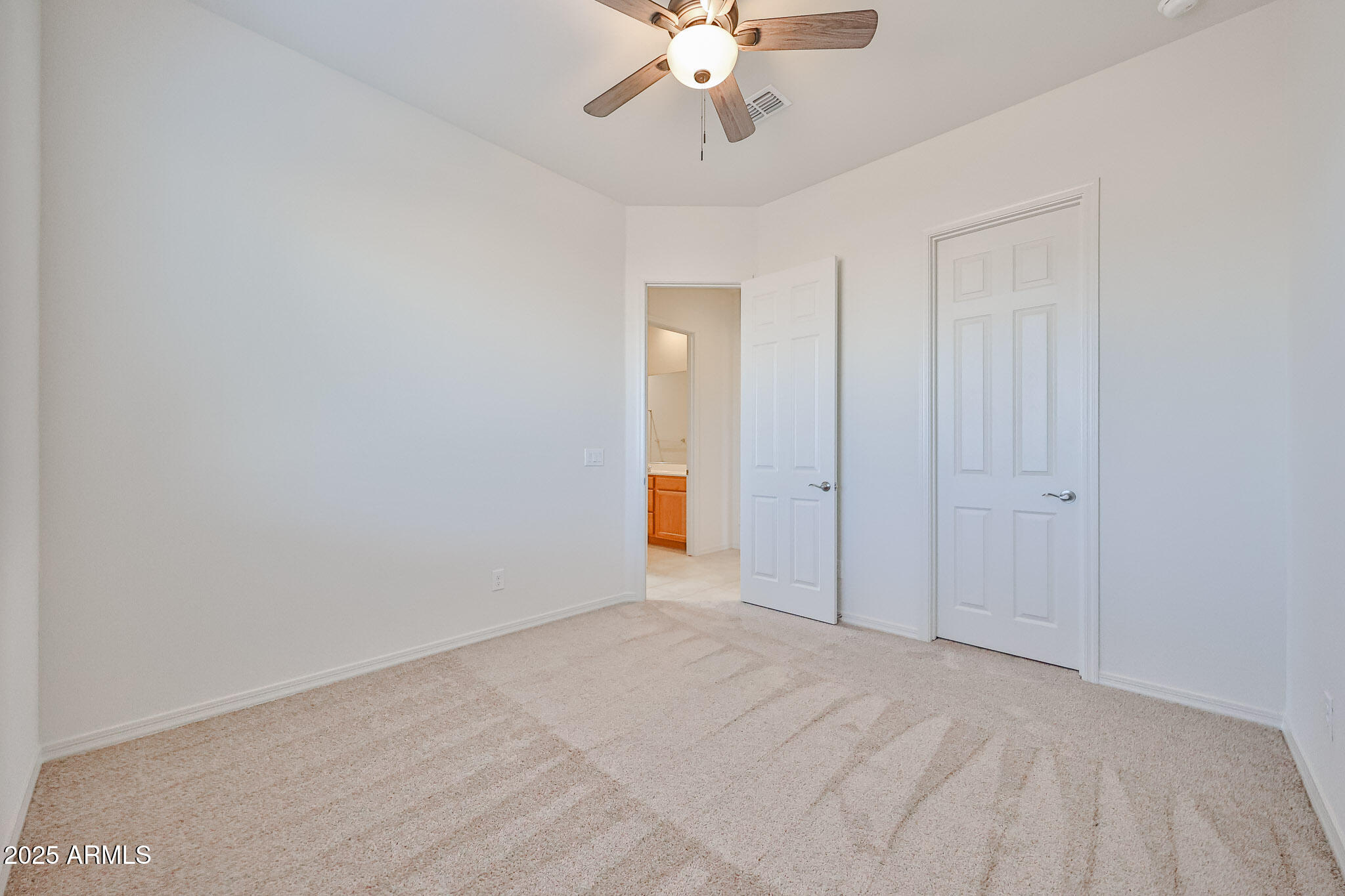 25079 North 171st Avenue Surprise, AZ 85387 - Photo 16 of 22 a view of an empty room and chandelier fan