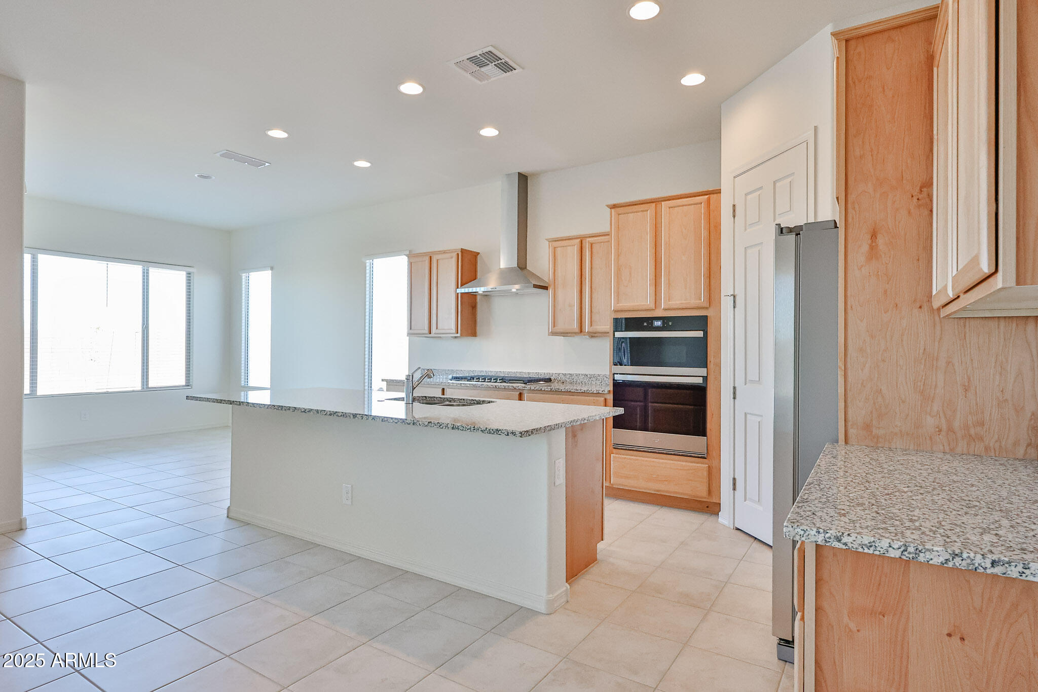 25079 North 171st Avenue Surprise, AZ 85387 - Photo 7 of 22 a kitchen with stainless steel appliances granite countertop a refrigerator and a sink