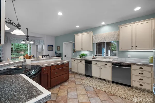 a kitchen with a sink stove and cabinets