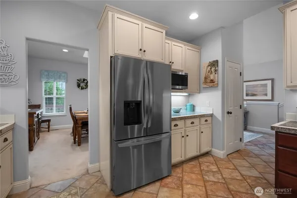 a kitchen with stainless steel appliances a refrigerator sink and cabinets