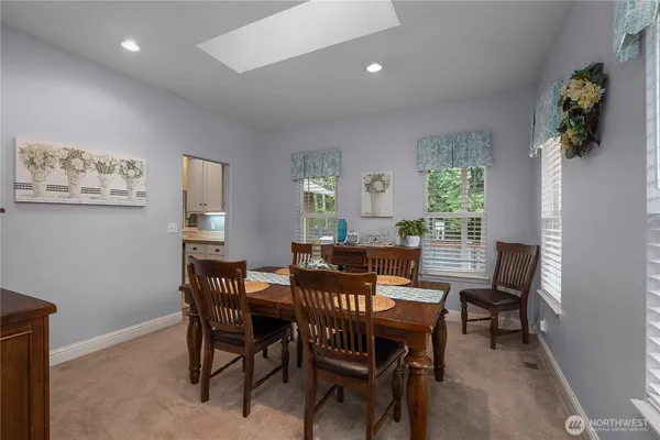 a view of a dining room with furniture and a window
