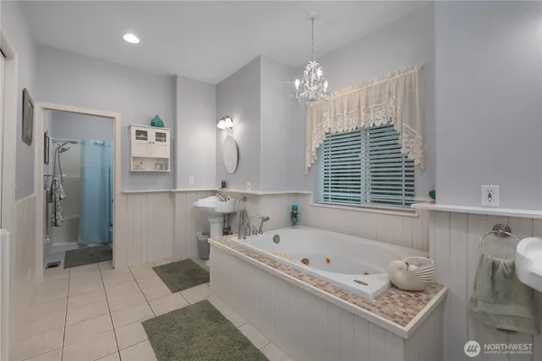 a bathroom with a tub sink and shower