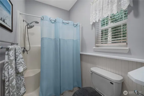 a bathroom with a shower curtain and a toilet