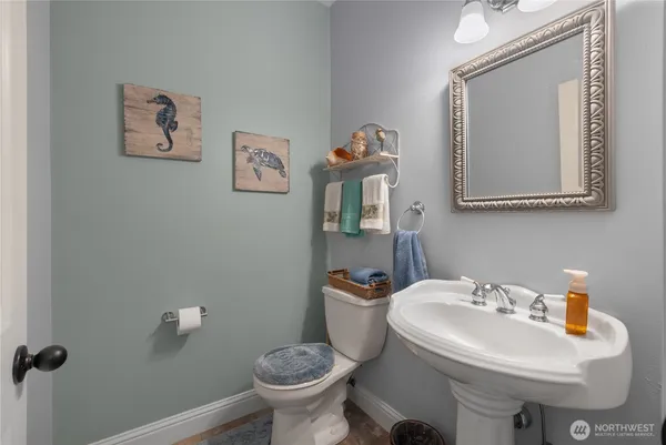 a bathroom with a toilet sink and mirror
