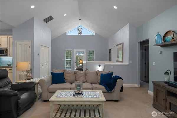 a view of a dining room with furniture and a chandelier