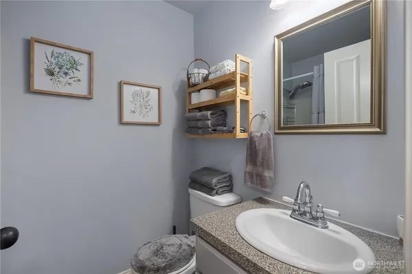 a bathroom with a toilet sink and mirror