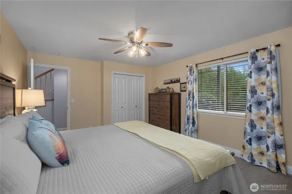 a bedroom with a large bed and a chandelier