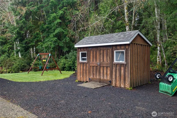 a backyard of a house with a yard and outdoor seating
