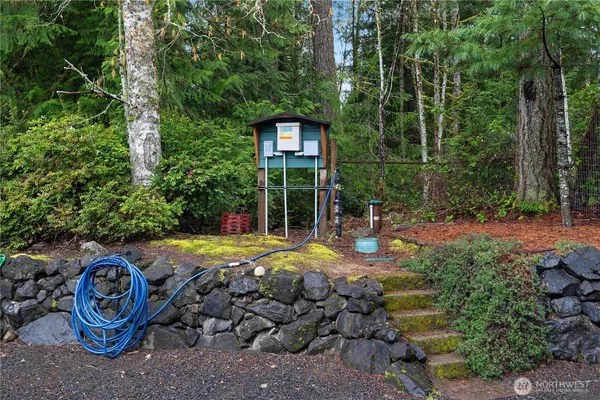 a view of a backyard with table and chairs and potted plants
