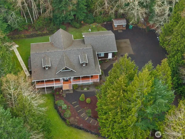 an aerial view of a house with a garden and a yard