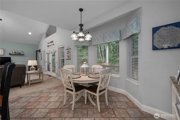 a view of a dining room with furniture and chandelier