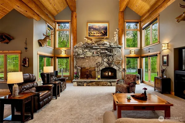 a living room with fireplace furniture a fireplace and a large window