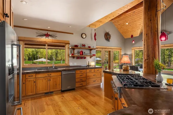 a kitchen with stainless steel appliances granite countertop a stove and a sink