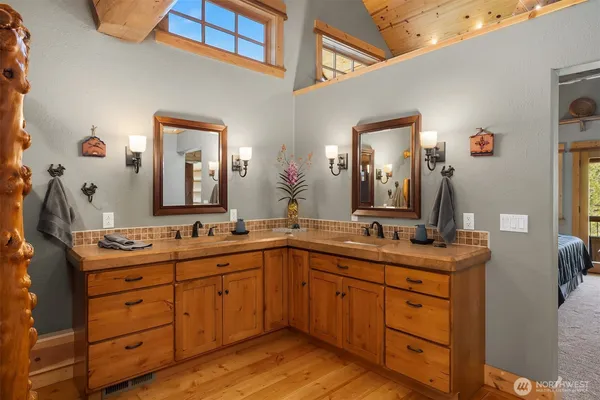 a bathroom with a double vanity sink and mirror
