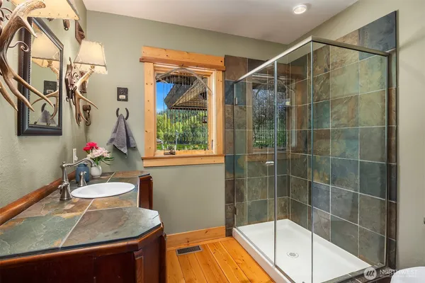a bathroom with a tub sink and mirror