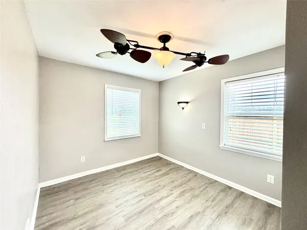 a view of a room with a window and wooden floor