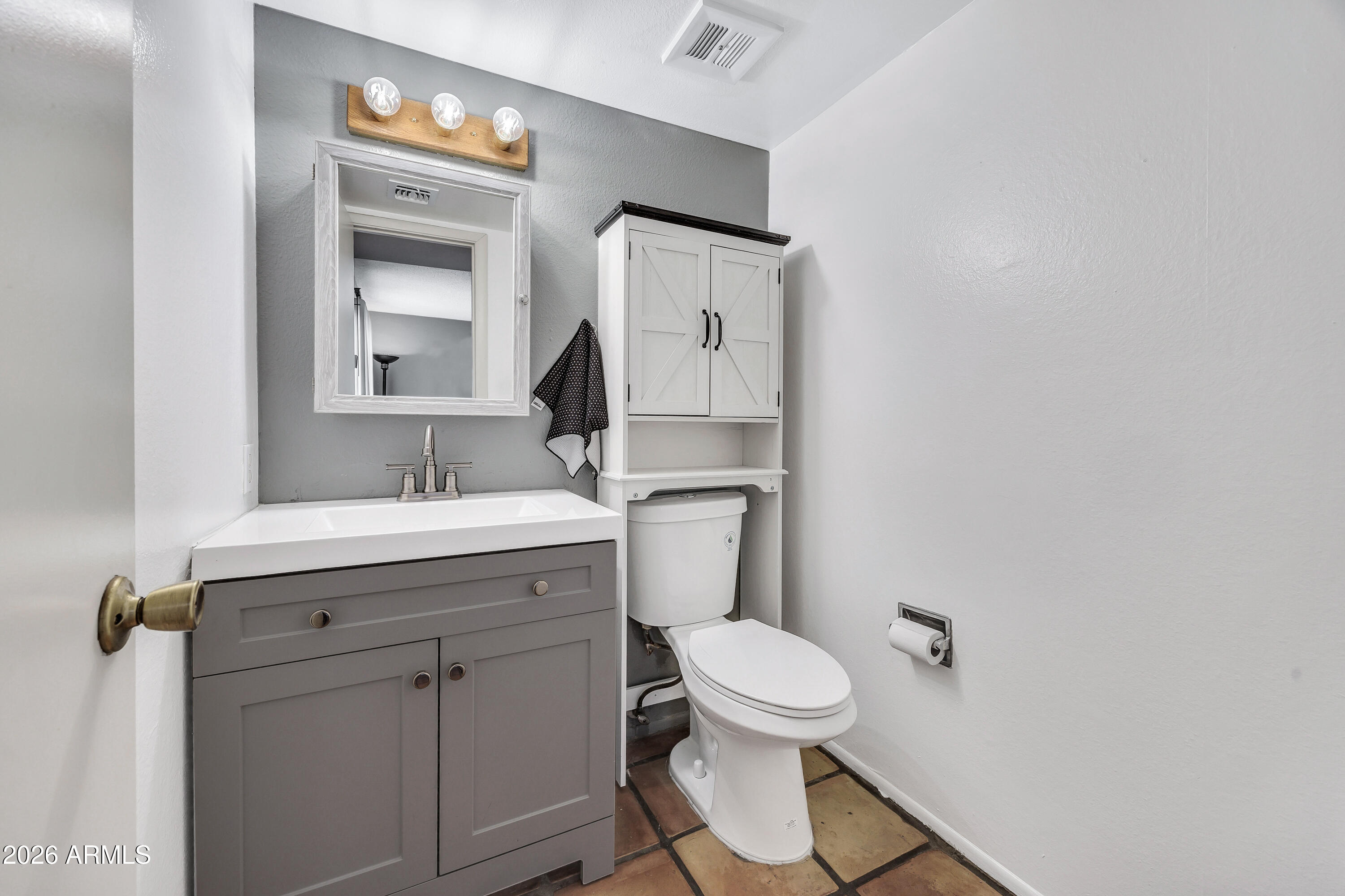 4604 East Riverside Street Phoenix, AZ 85040 - Photo 16 of 24 a bathroom with a toilet sink and mirror