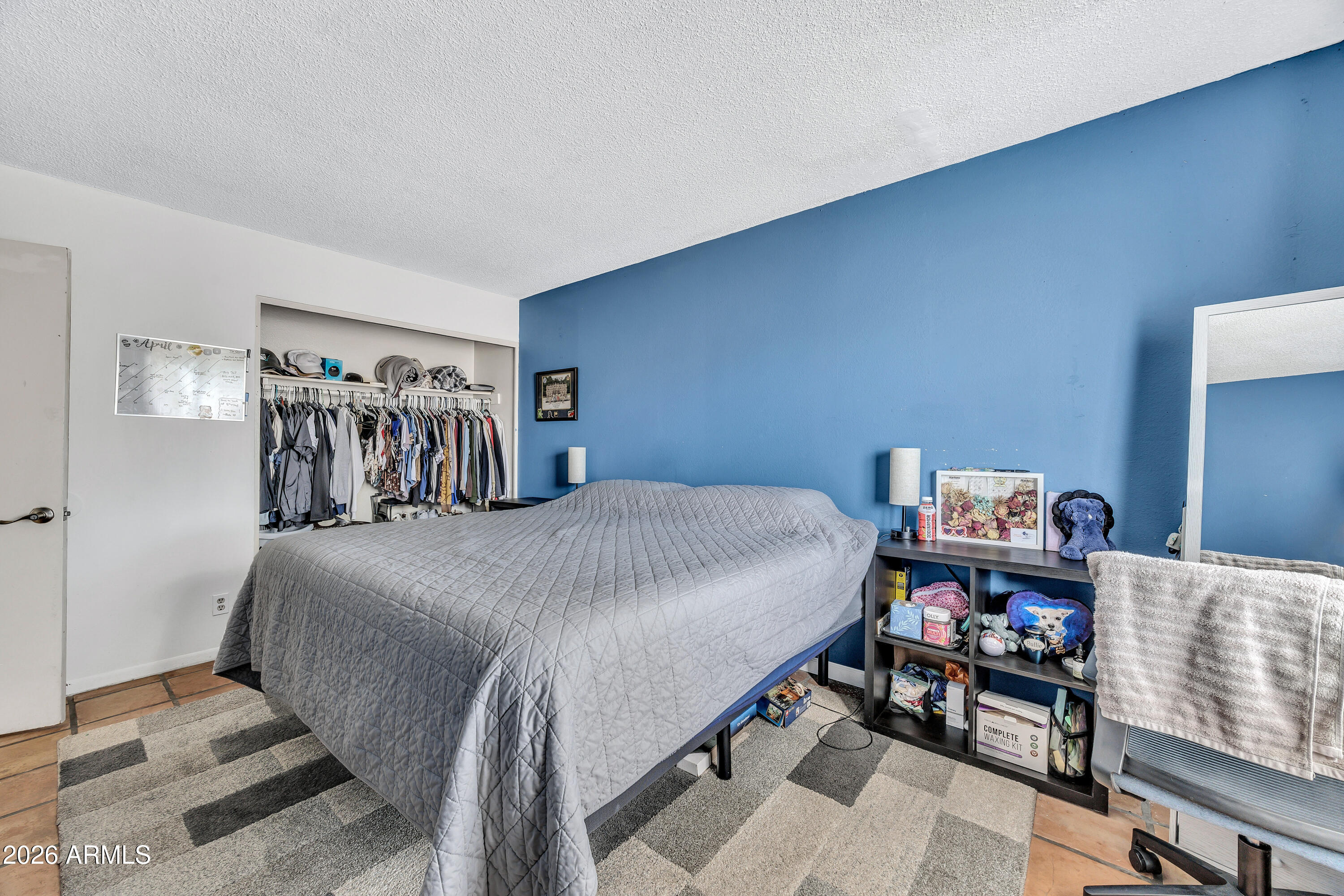 4604 East Riverside Street Phoenix, AZ 85040 - Photo 18 of 24 a bedroom with a bed and closet
