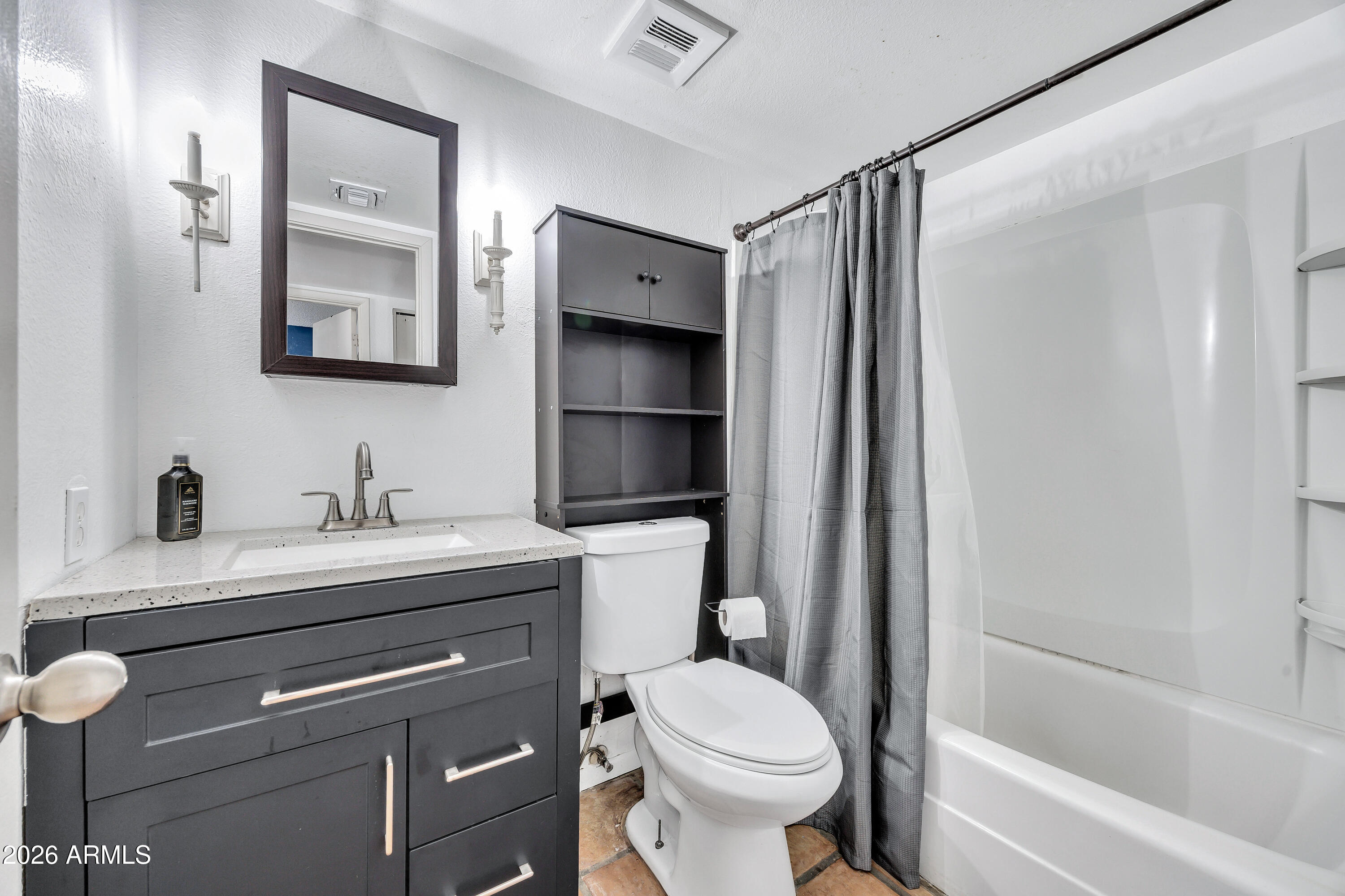 4604 East Riverside Street Phoenix, AZ 85040 - Photo 19 of 24 a bathroom with a sink a toilet and shower