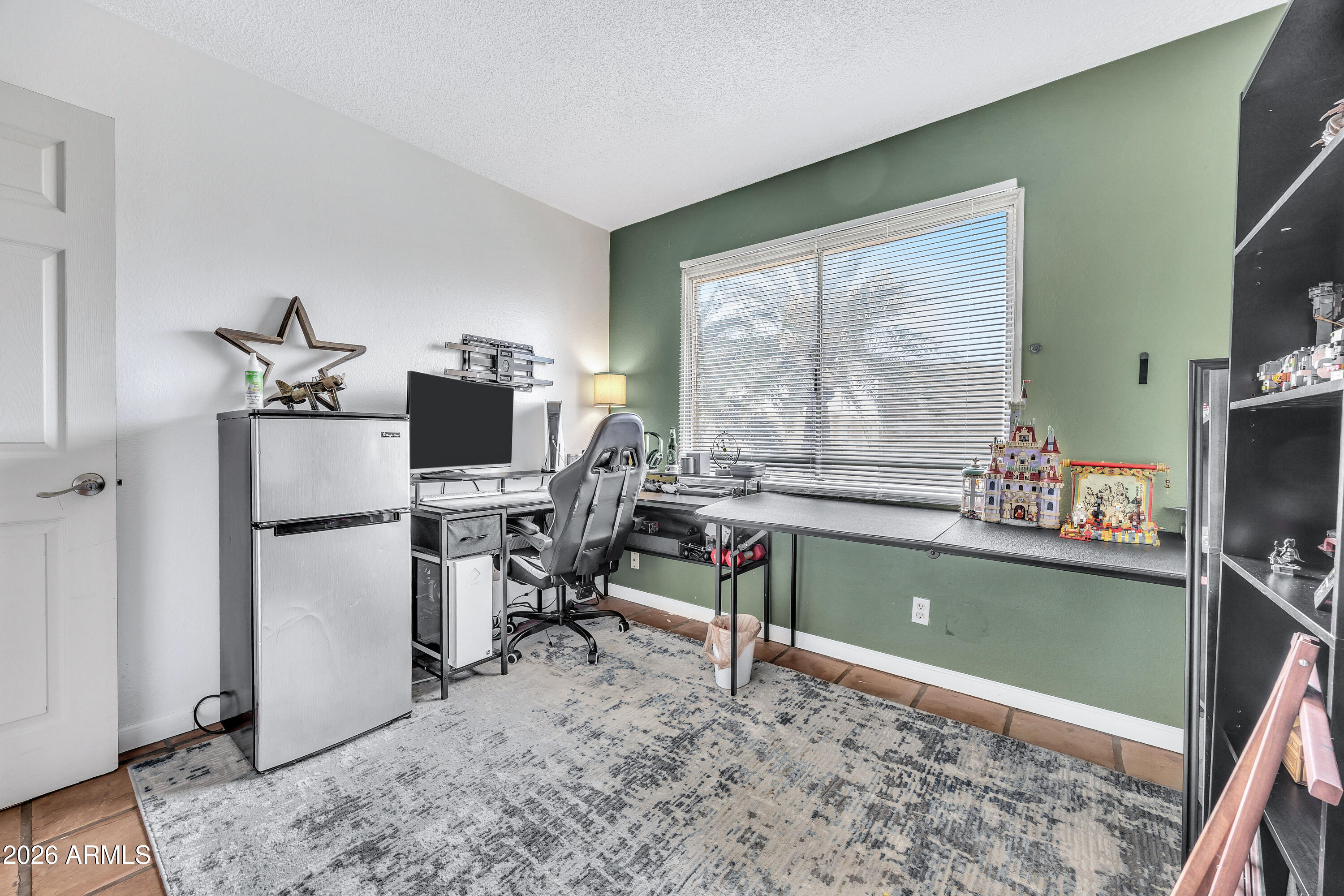 4604 East Riverside Street Phoenix, AZ 85040 - Photo 21 of 24 a room with furniture and a flat screen tv