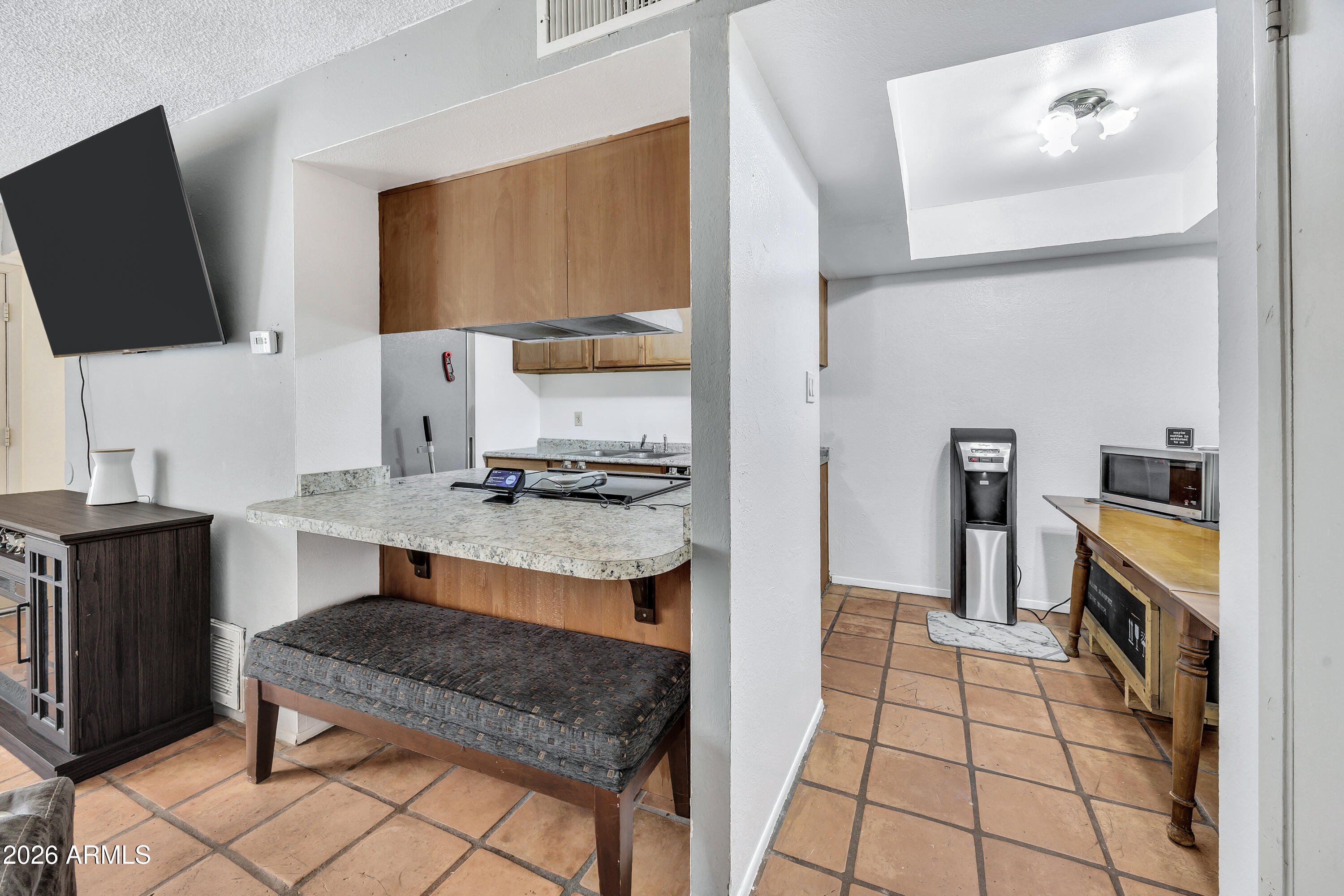 4604 East Riverside Street Phoenix, AZ 85040 - Photo 9 of 24 a kitchen with granite countertop a stove and a sink