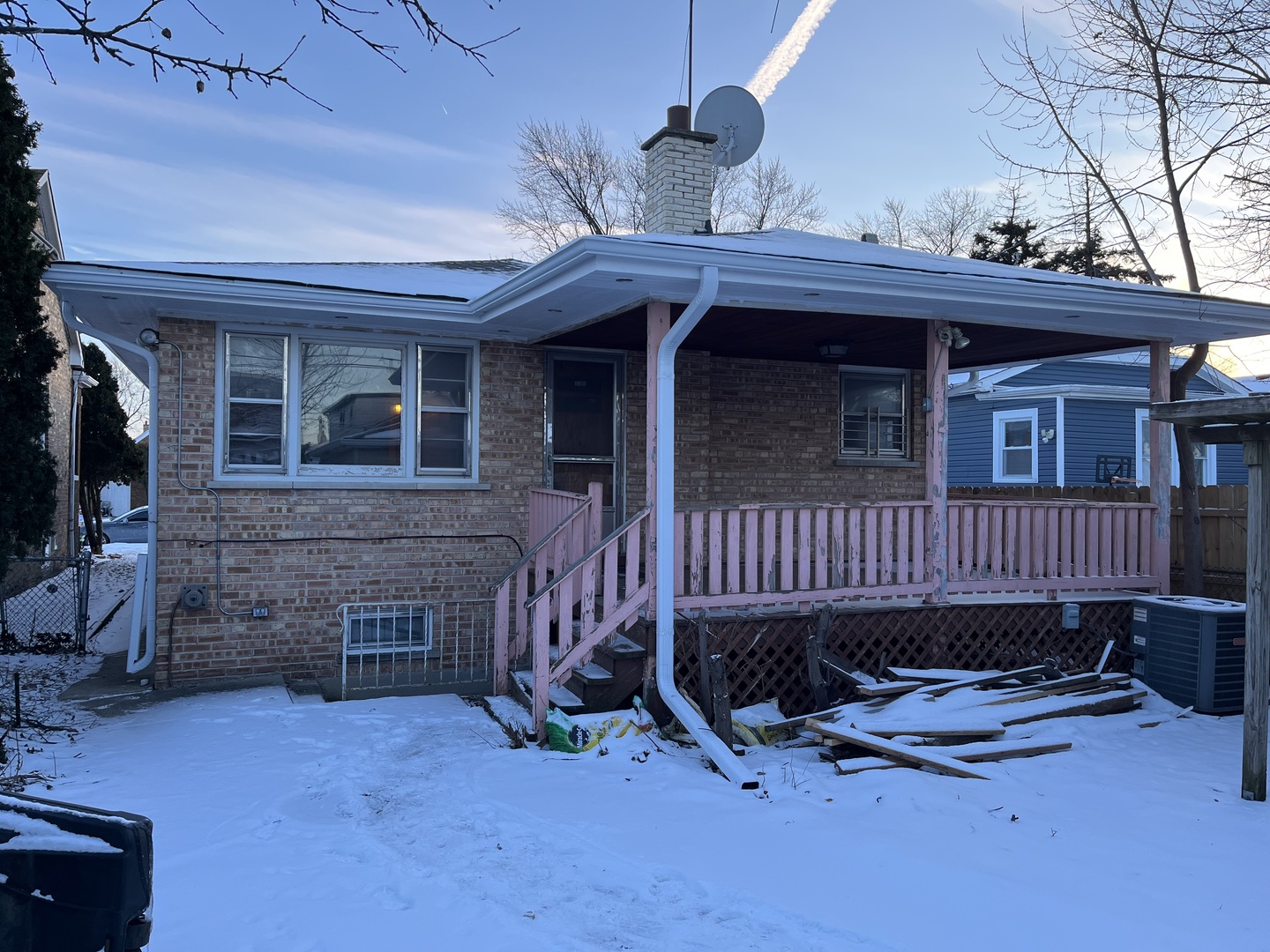 6142 West Barry Avenue Chicago, IL 60634 - Photo 2 of 12 a view of a house with a patio and wooden fence