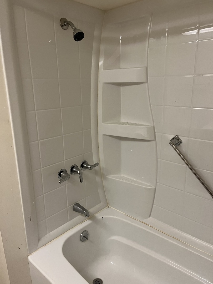 6142 West Barry Avenue Chicago, IL 60634 - Photo 5 of 12 a bathroom with a tub