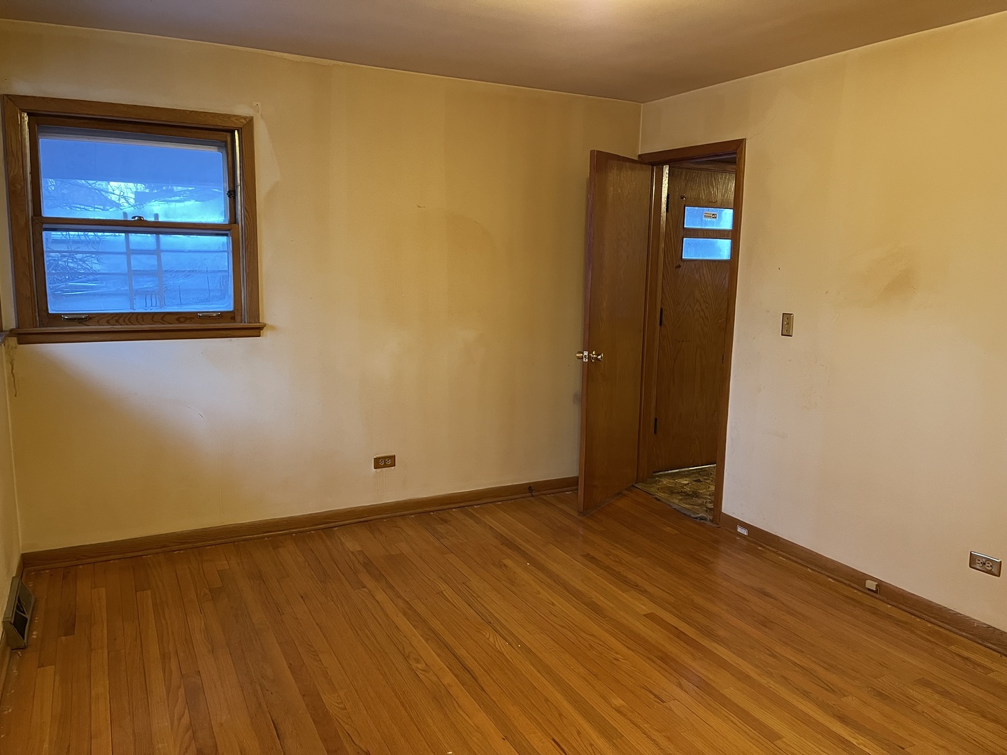 6142 West Barry Avenue Chicago, IL 60634 - Photo 10 of 12 an empty room with wooden floor and windows