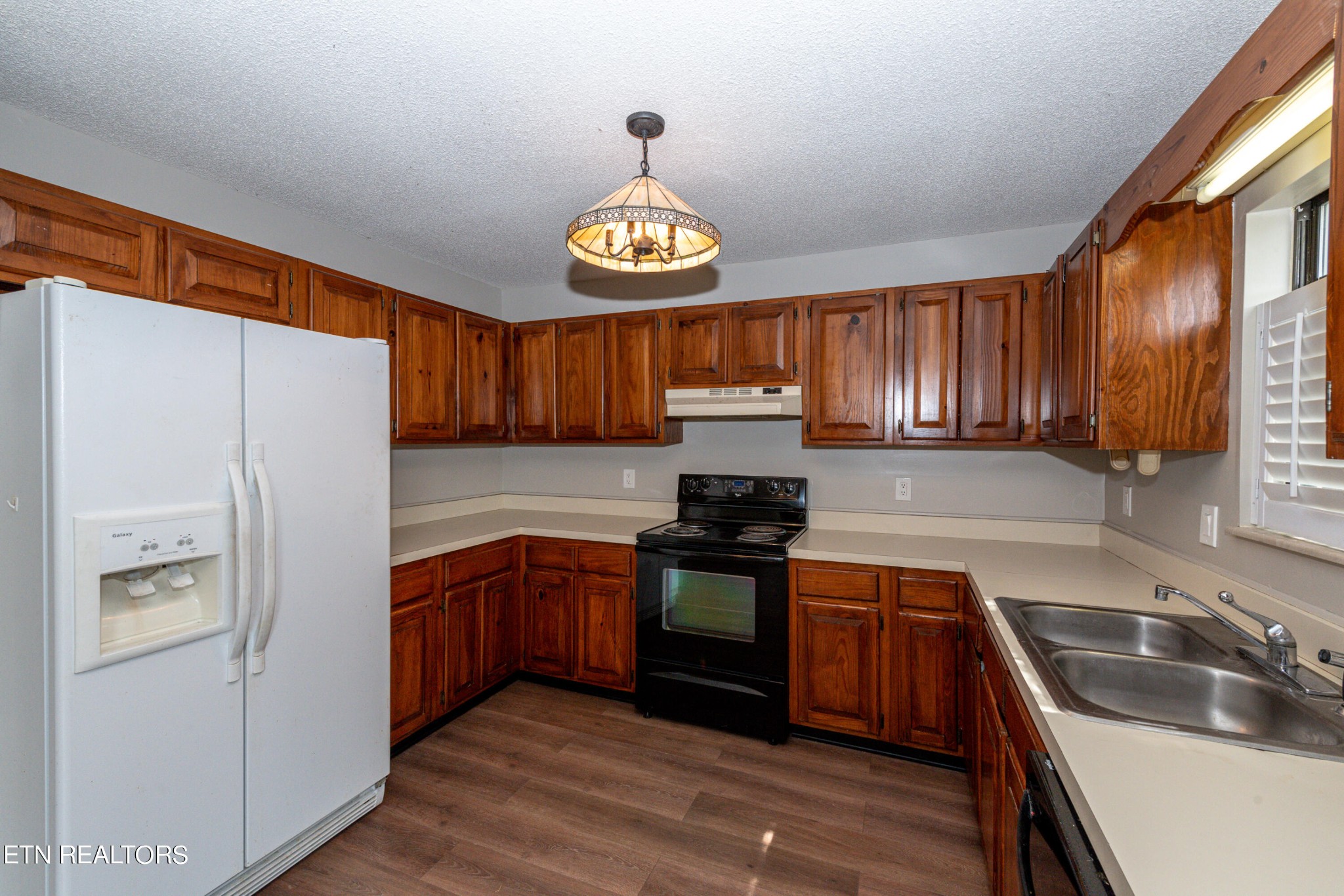 1318 Raulston Road Maryville, TN 37803 - Photo 11 of 28 a kitchen with granite countertop wooden cabinets a stove a sink and a stainless steel appliances