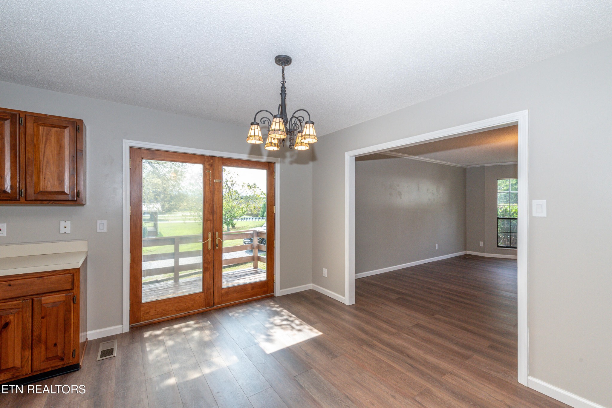 1318 Raulston Road Maryville, TN 37803 - Photo 12 of 28 a view of an empty room with wooden floor and a window