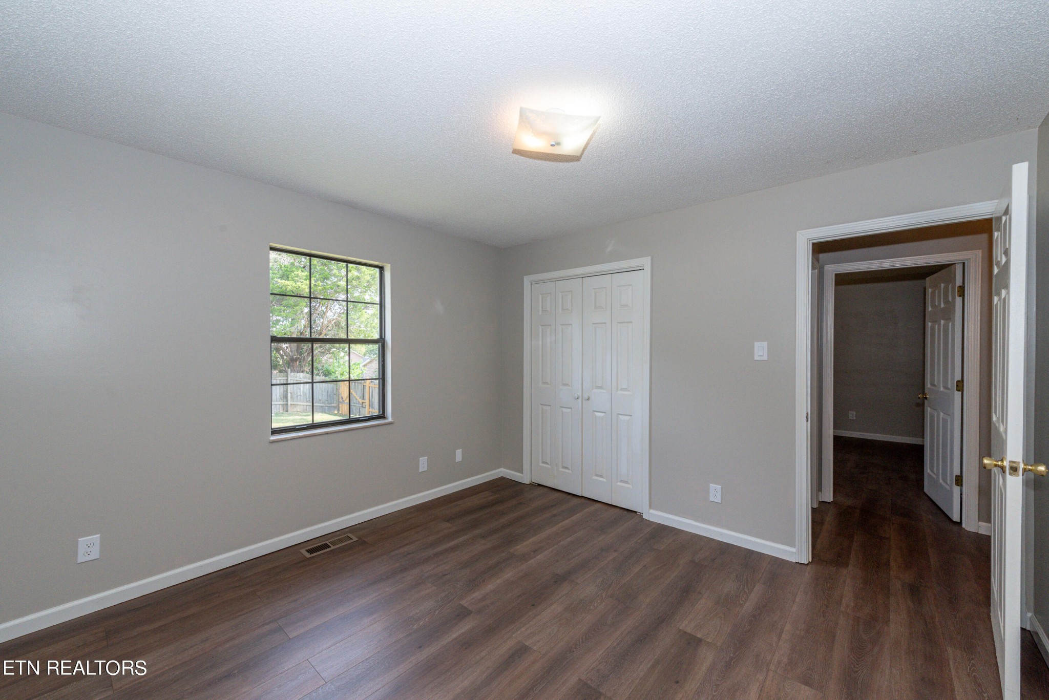1318 Raulston Road Maryville, TN 37803 - Photo 15 of 28 wooden floor in an empty room with a window