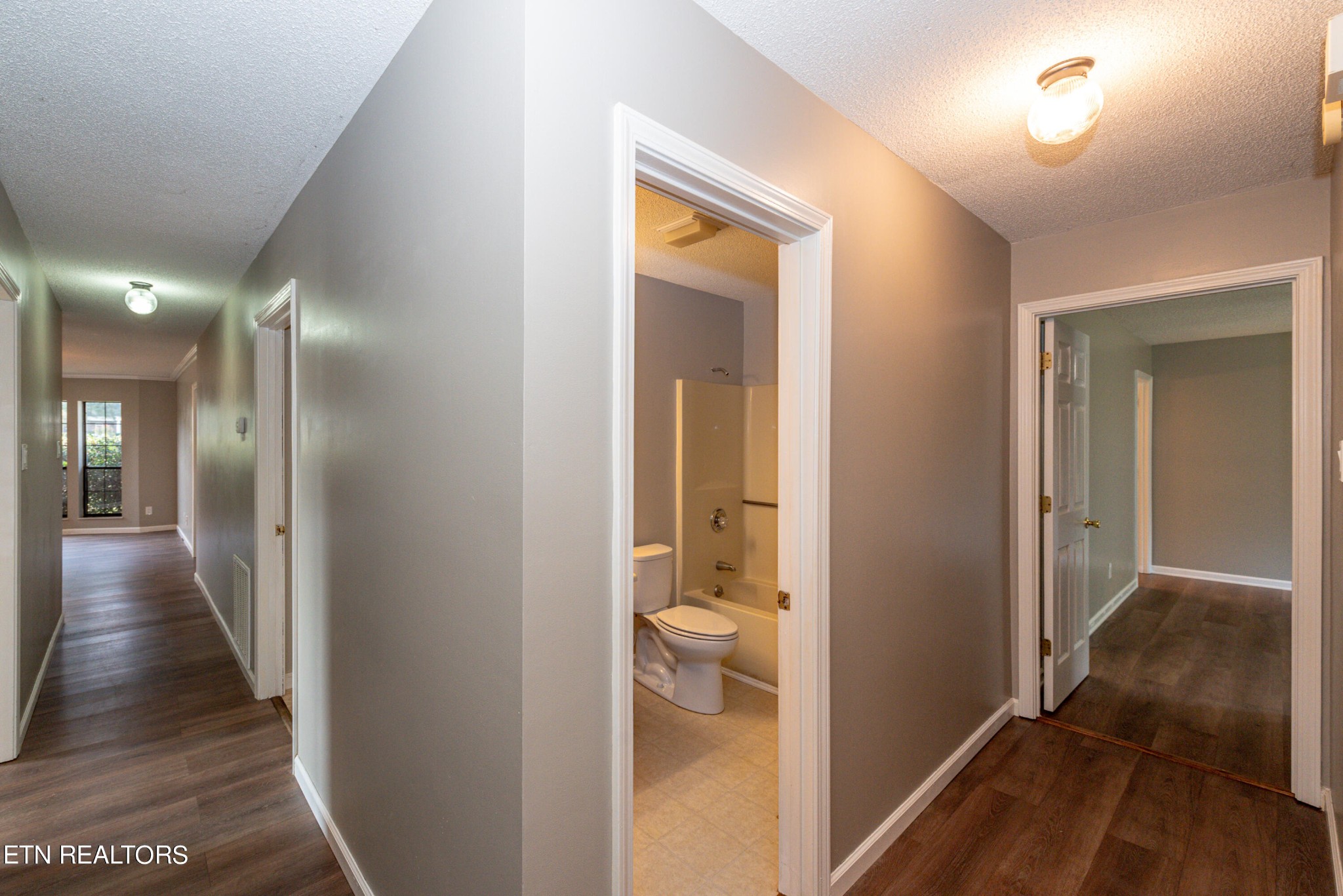 1318 Raulston Road Maryville, TN 37803 - Photo 16 of 28 a view of a hallway with wooden floor and a bathroom