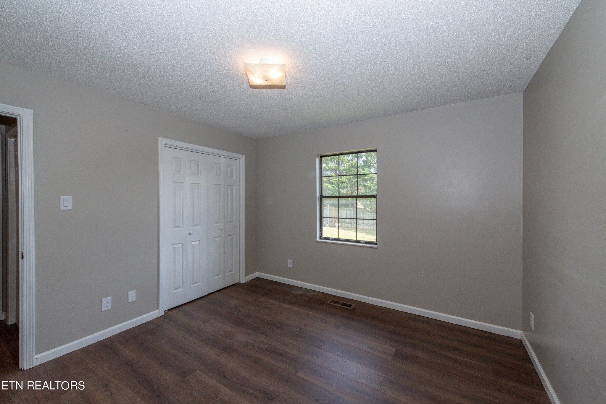 1318 Raulston Road Maryville, TN 37803 - Photo 19 of 28 an empty room with wooden floor and windows