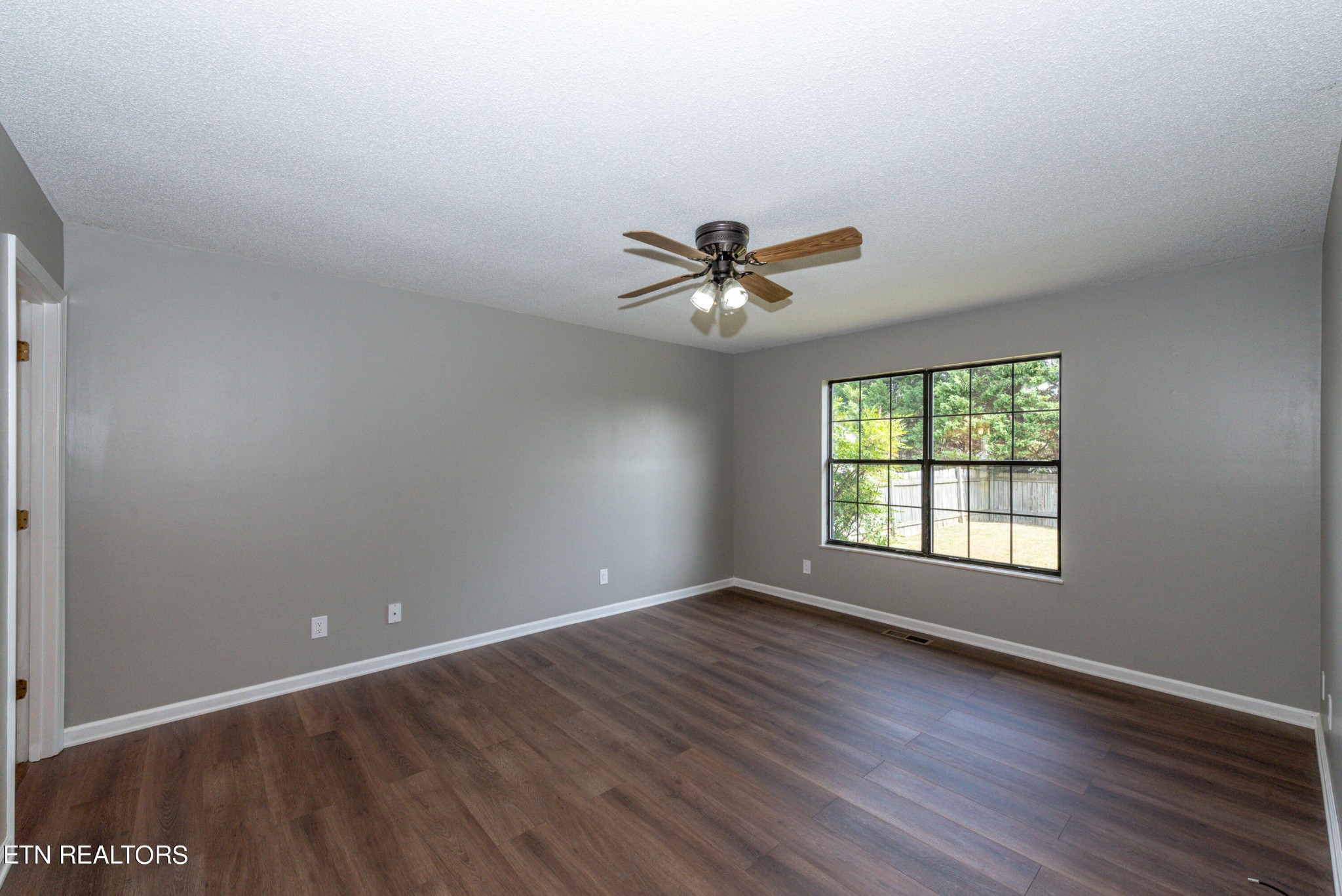 1318 Raulston Road Maryville, TN 37803 - Photo 22 of 28 a view of an empty room with a window and wooden floor