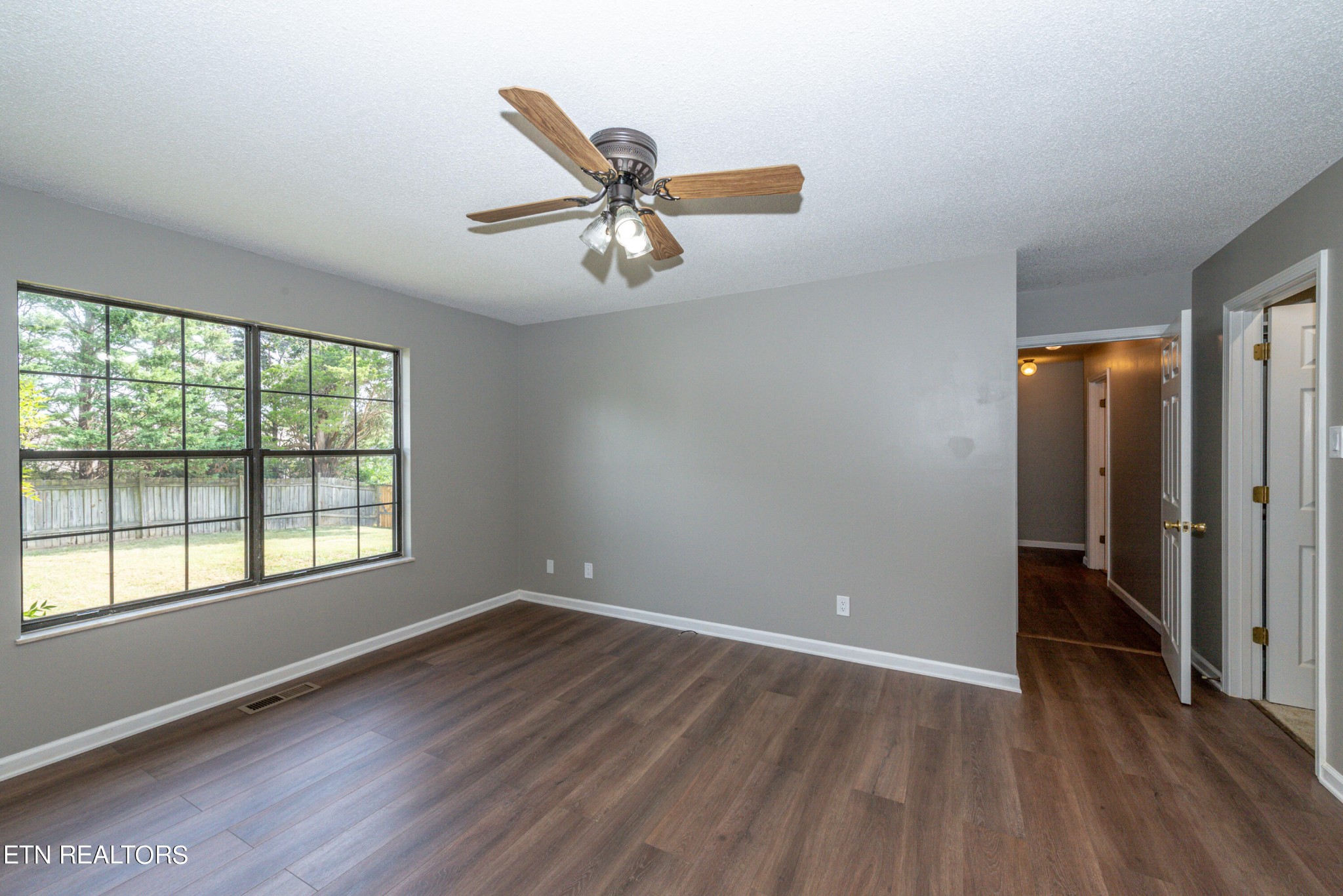 1318 Raulston Road Maryville, TN 37803 - Photo 23 of 28 an empty room with wooden floor fan and windows