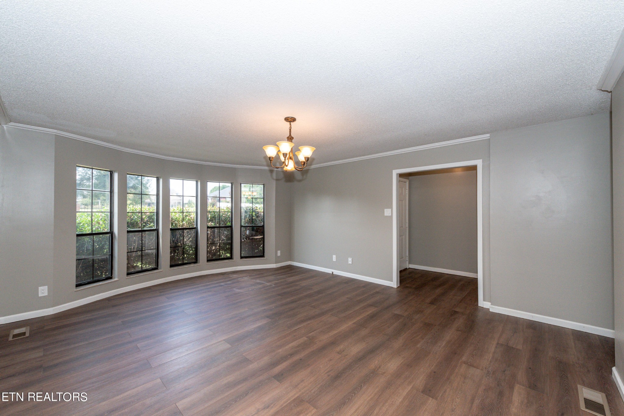 1318 Raulston Road Maryville, TN 37803 - Photo 4 of 28 a view of an empty room with wooden floor and a window
