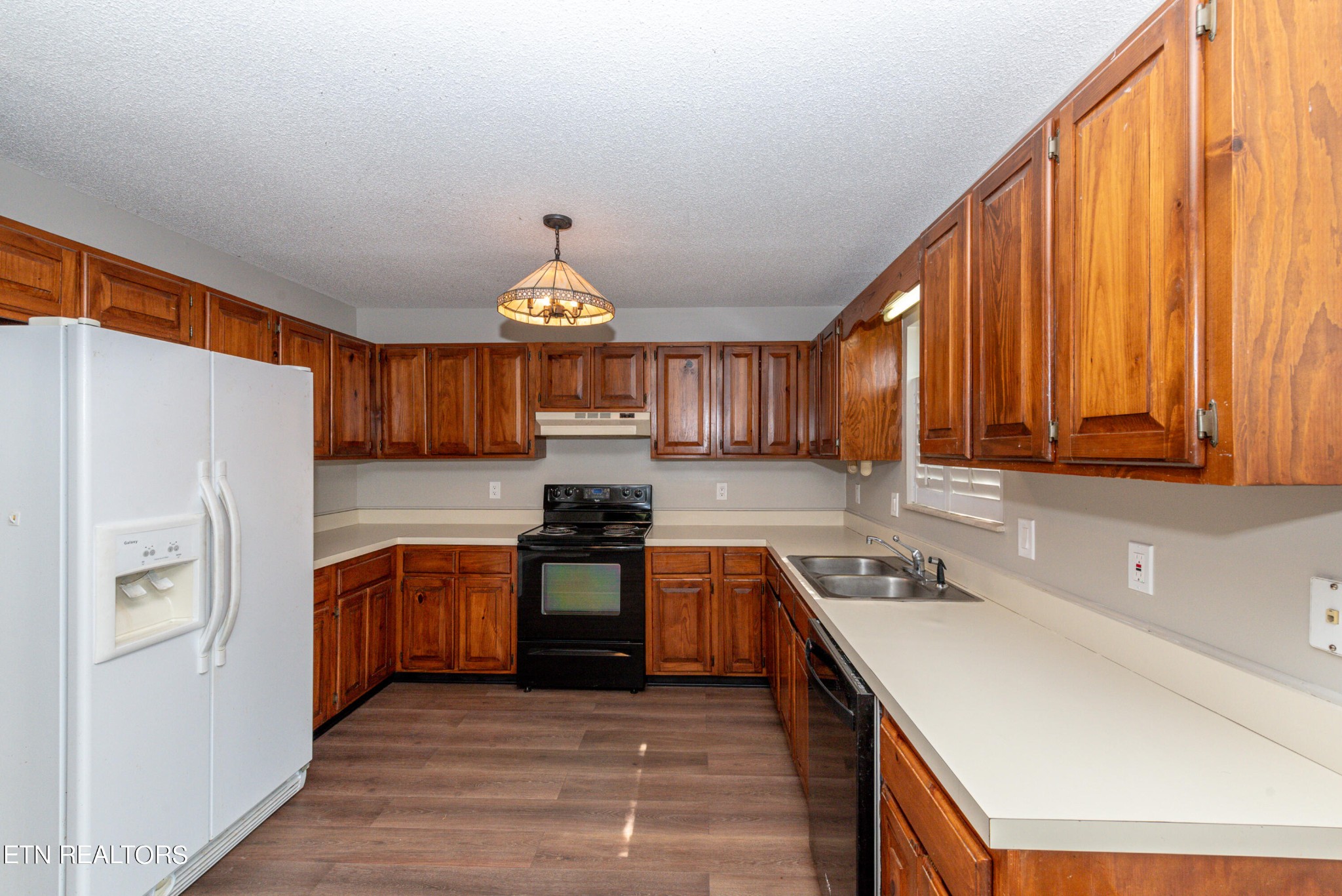 1318 Raulston Road Maryville, TN 37803 - Photo 9 of 28 a kitchen with stainless steel appliances granite countertop a stove a sink dishwasher and a refrigerator