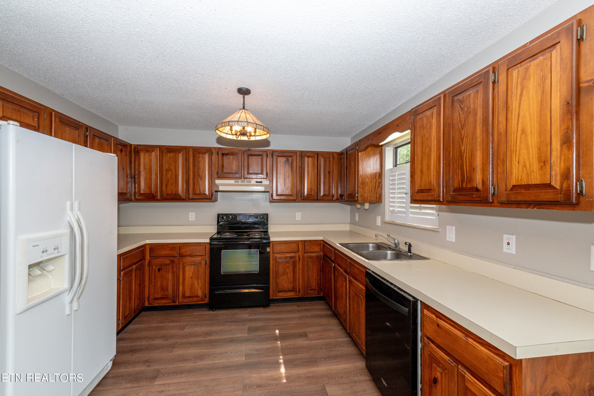 1318 Raulston Road Maryville, TN 37803 - Photo 10 of 28 a kitchen with stainless steel appliances granite countertop a sink stove and refrigerator